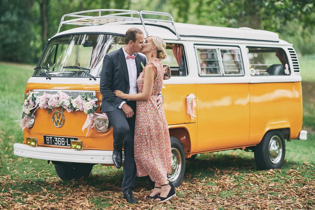 Baiser devant un combi Volkswagen jaune fleuri